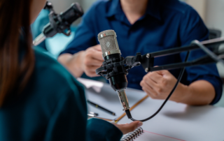 Podcast setup with microphones and notepad on table