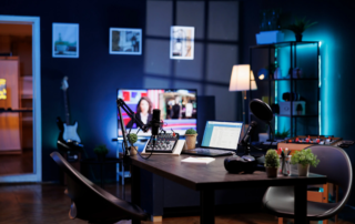Podcast recording setup with microphone mixer laptop and monitor