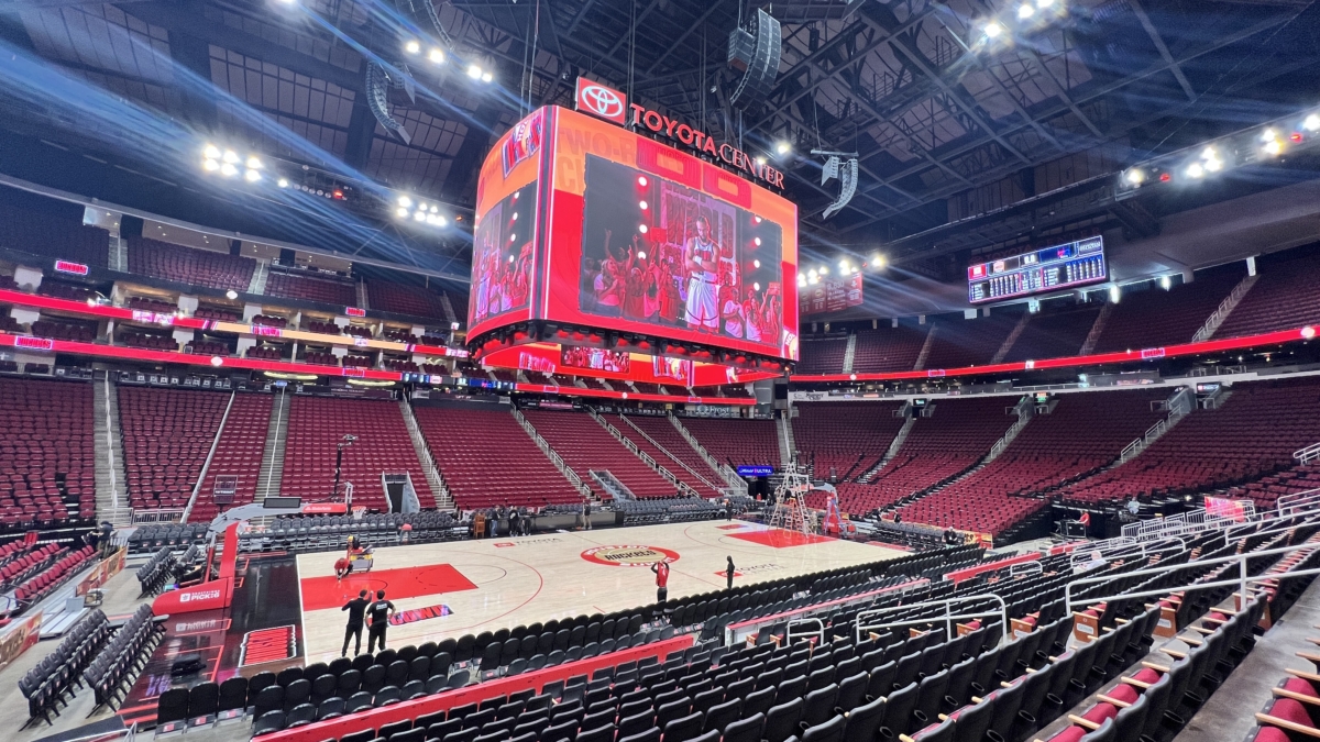 jumbotron scoreboard displaying liftoff schedule above empty arena seating