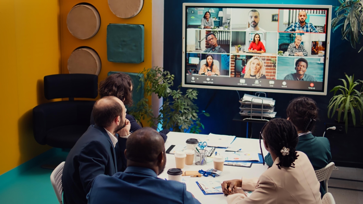 Virtual team meeting with physical office people