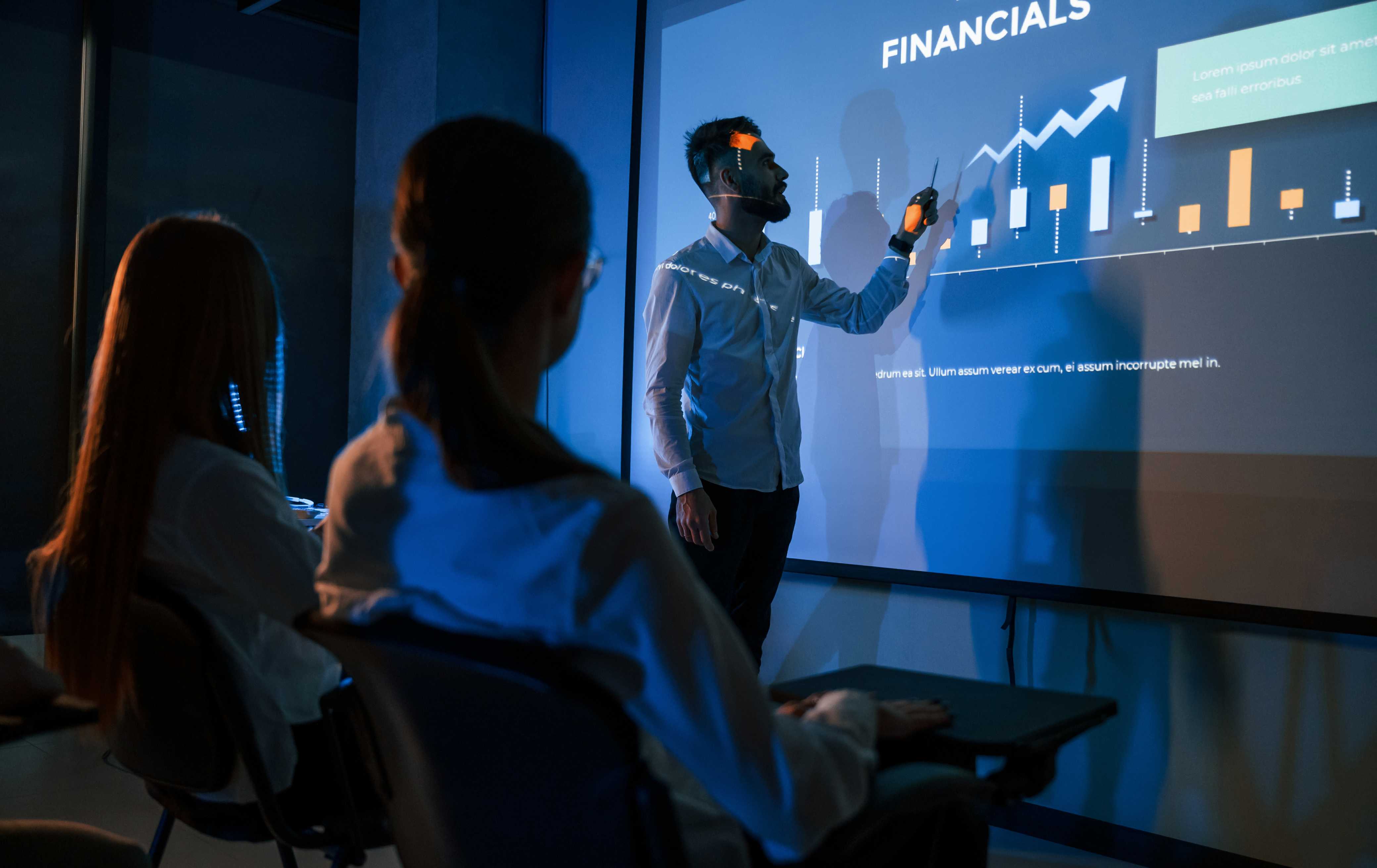 Man showing plan or graph on LED screen