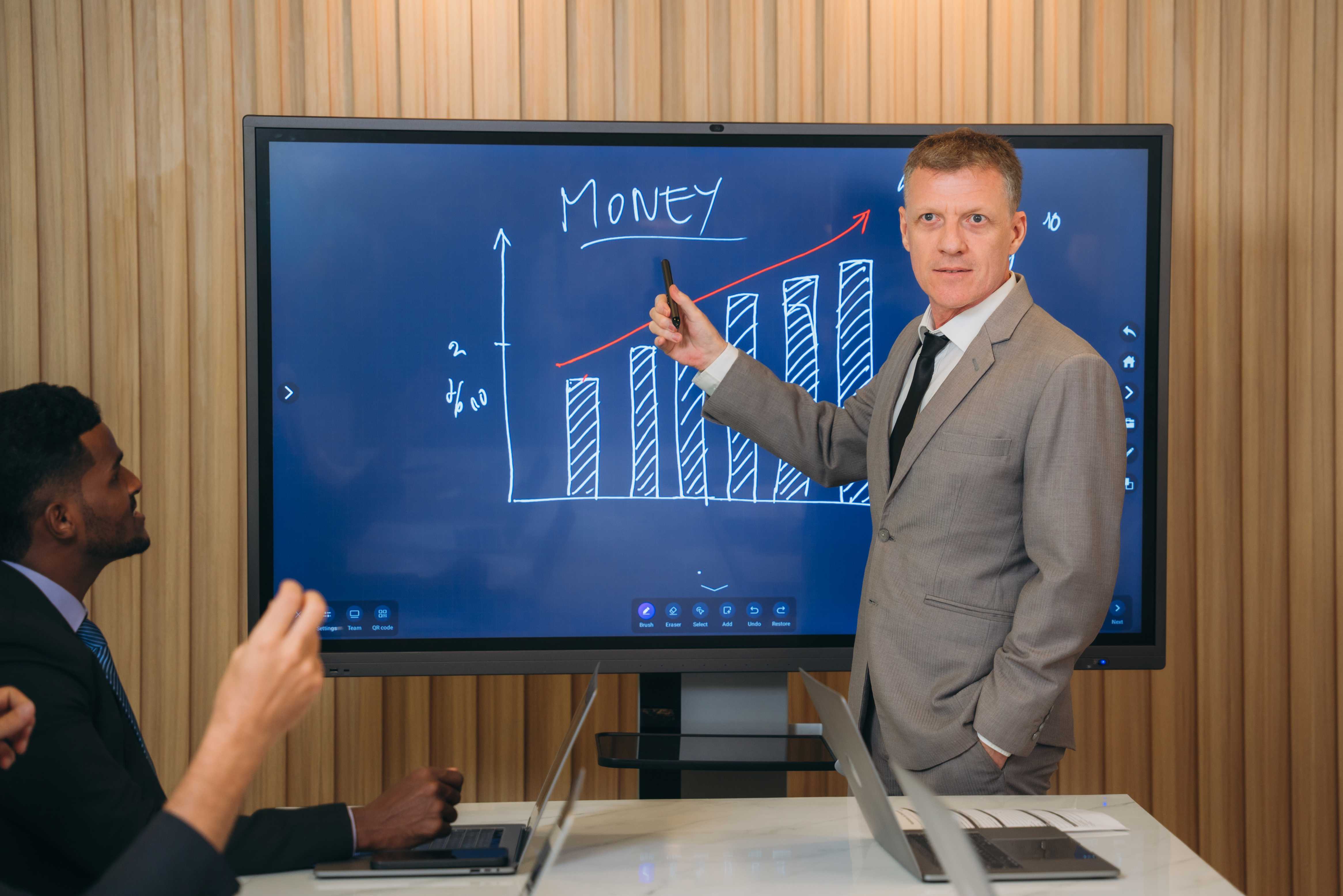 Man giving presentation on a large LED TV