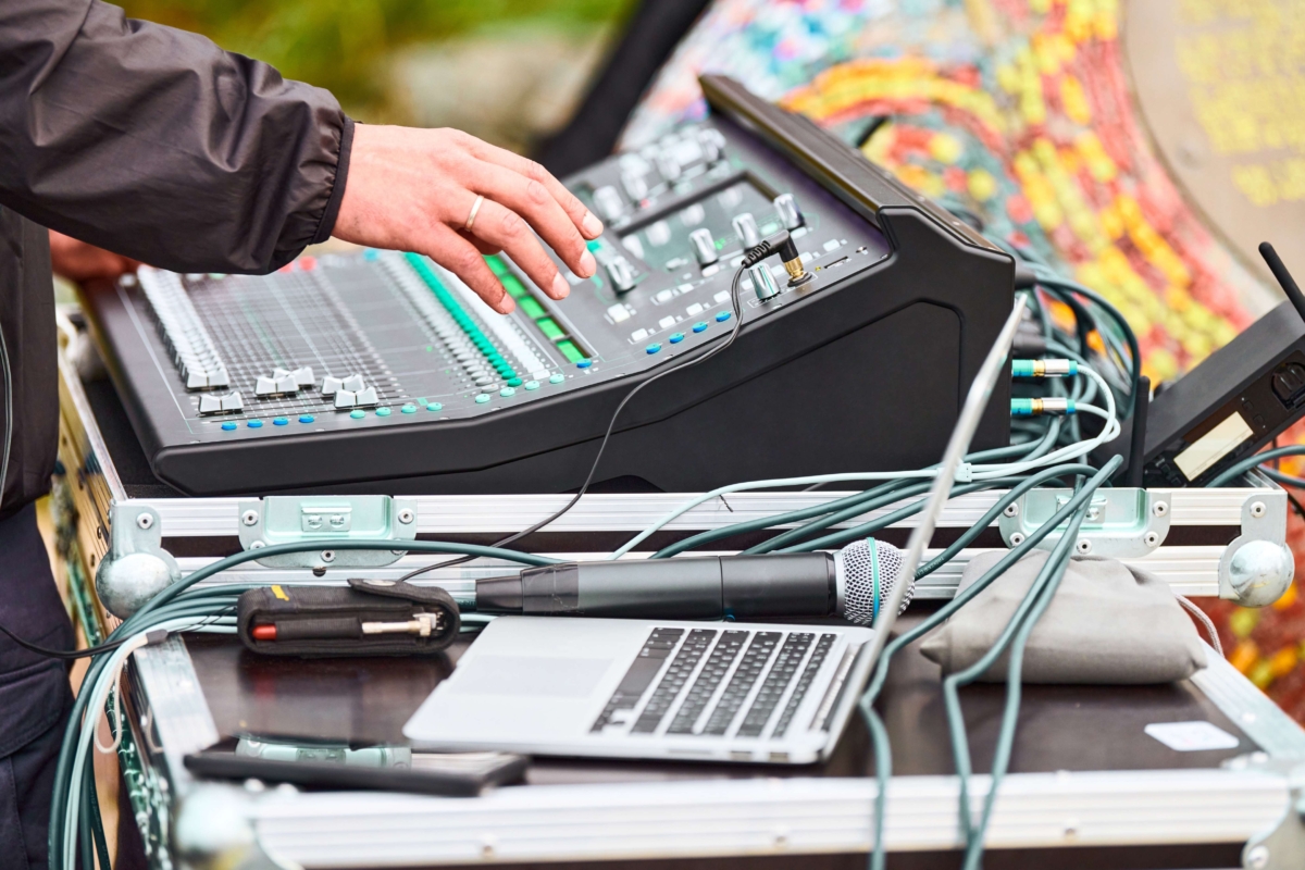sound engineer hands working on sound mixer at live event