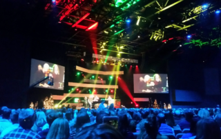 Live concert with red and green stage lights 2 LED walls and people cheering