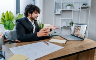 Businessman using laptop sitting in office