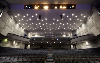 Cinema auditorium with stage lights and chairs