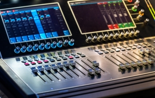 Mixing console with faders and knobs adjusting