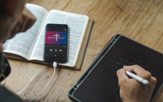men holding mobile phone praying worship to god