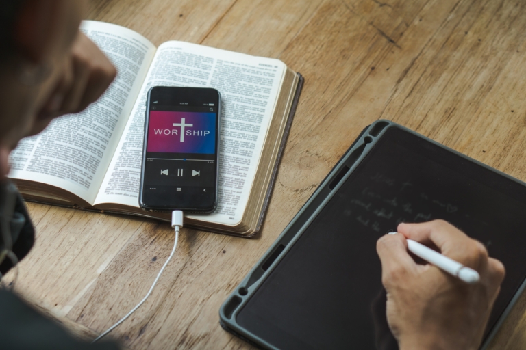 men holding mobile phone praying worship to god